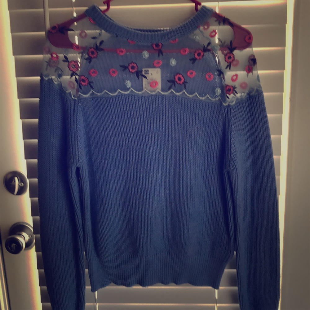 woven blue blouse with stamped colorful flowers.
